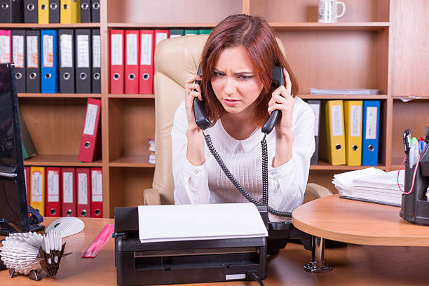 istock disappointed woman with two handsets 496166506