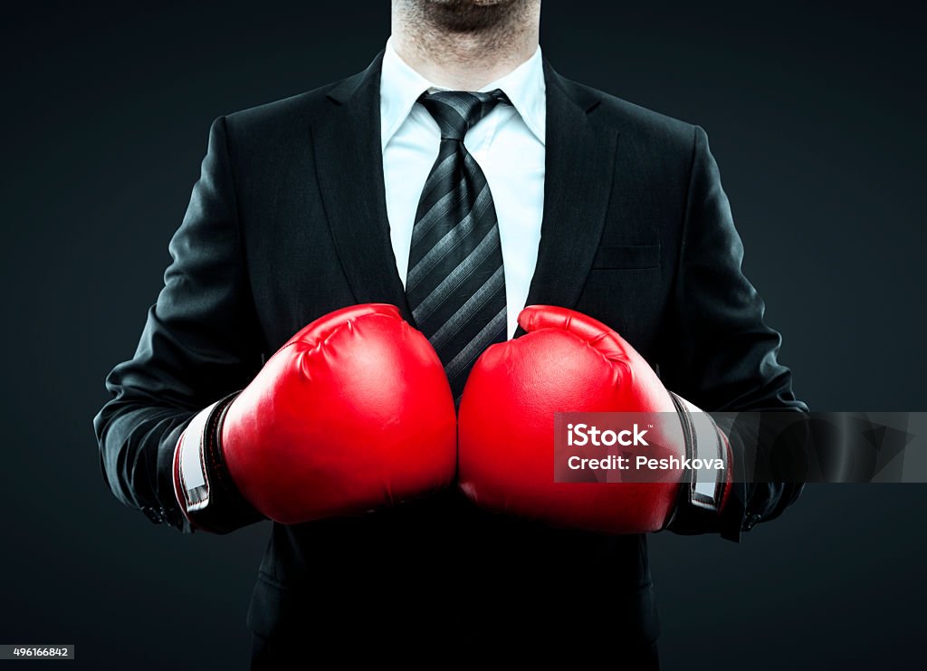 businessman in boxing gloves businessman in boxing gloves isolated on gray Boxing - Sport Stock Photo