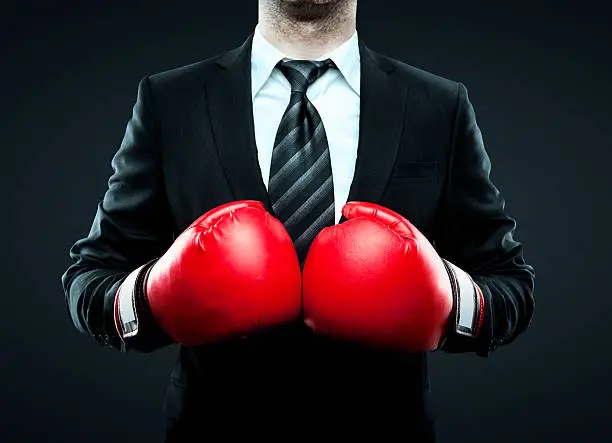 businessman in boxing gloves isolated on gray