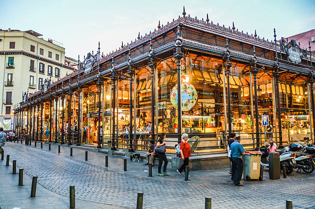 Madrid, Spain - August 6, 2015: Tourists visiting the famous San Miguel Market, Madrid. The market wants to be part of the agenda of Madrid events doing different activities related to leisure and culture, helping to revitalize the old capital.