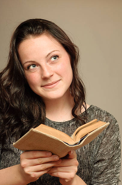 istock Young Woman Reads and Considers 496195695