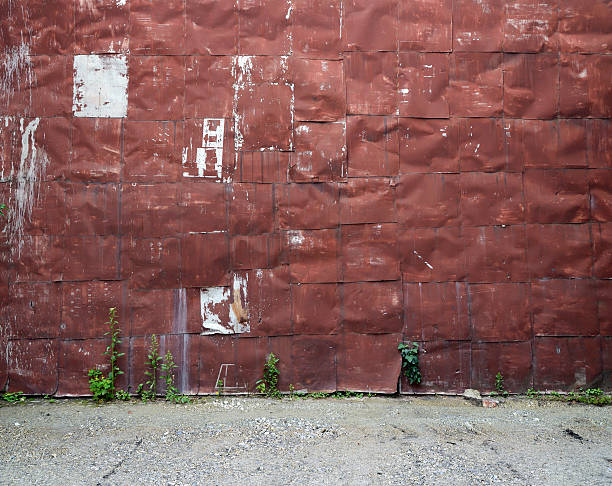 istock old riveted metal wall with gravel floor 496195749