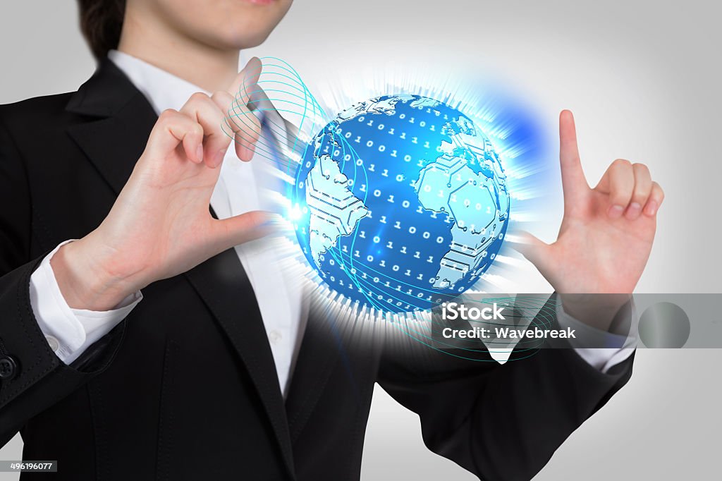 Businesswoman touching globe with binary code Digital composite of businesswoman touching globe with binary code 20-24 Years Stock Photo