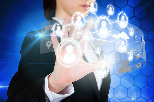 Digital composite of businesswoman touching interface with profile pictures