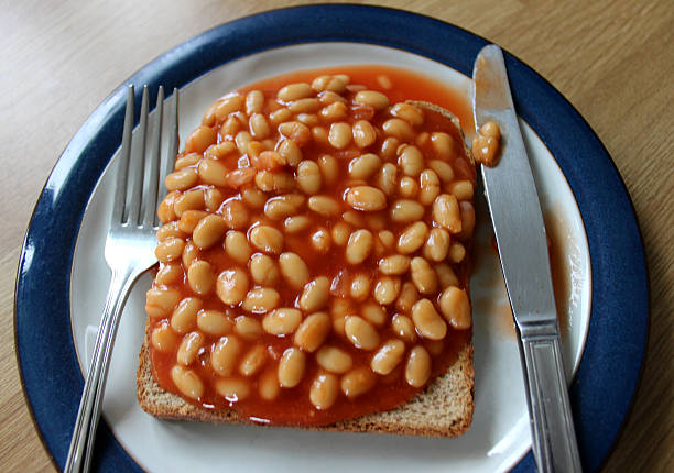 istock Image of baked beans on toast (wholemeal bread), with cutlery 496199013