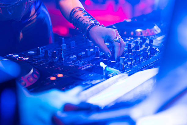 real woman dj playing music at party stock photo