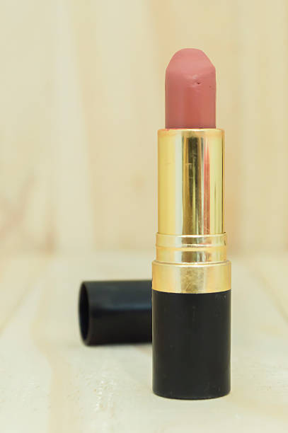 istock Nude colour lipstick on wood background 496206524