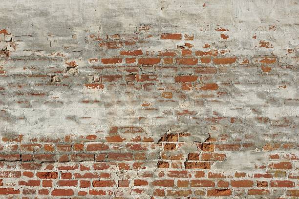 istock White Red Old Brick Painted Wall With Damaged Plaster 496207416