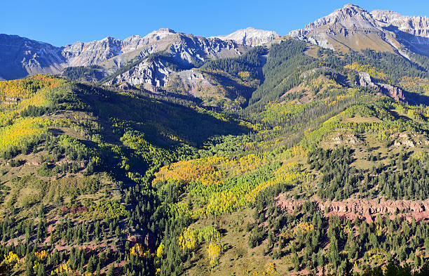 istock snow covered mountains and yellow aspen 496207482