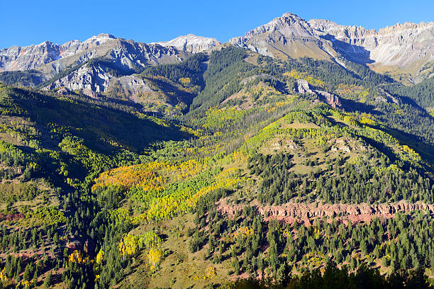 istock snow covered mountains and yellow aspen 496207492