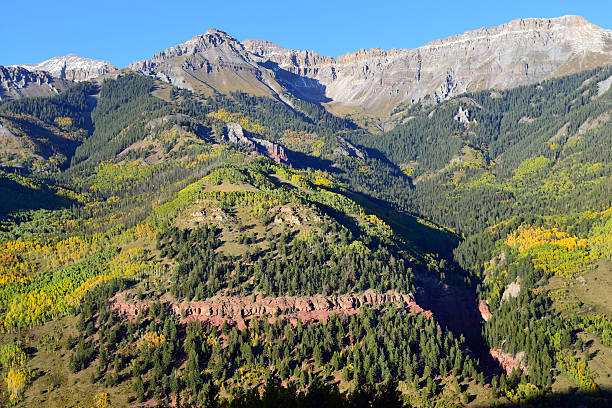 istock snow covered mountains and yellow aspen 496208102