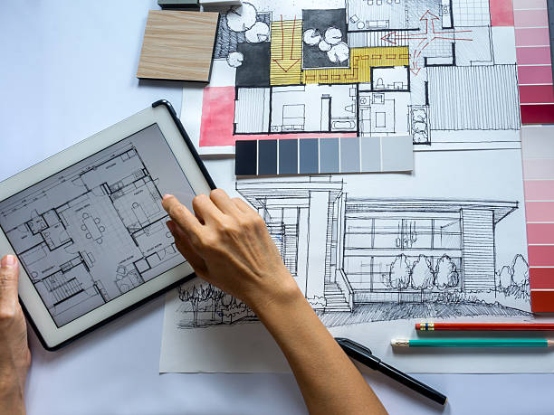 istock Top view of Architects/ Interior designers hands working with tablet 496209738