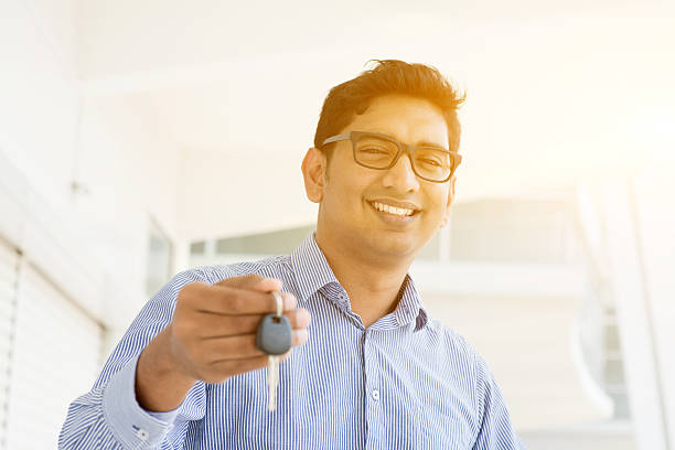 istock Man hand holding new key 496210952