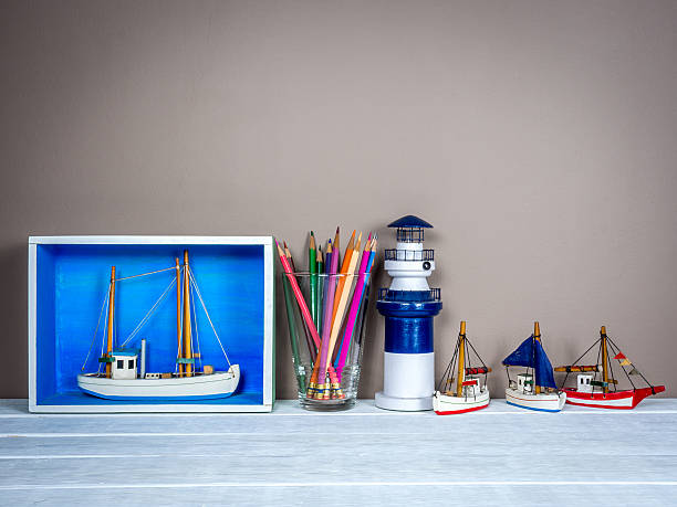 Interior still-life, boat  miniature on wooden table top/ home improvement concept