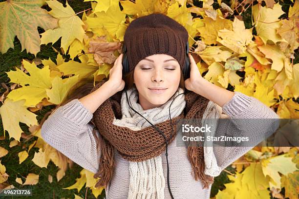 Young Woman Listening To Music On An Autumns Day Stock Photo - Download Image Now - 2015, Adult, Adults Only