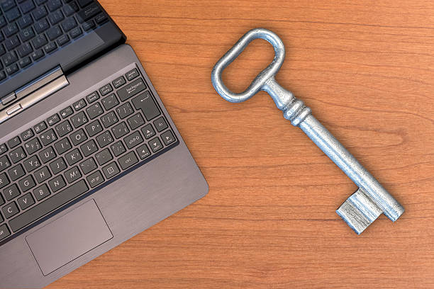 istock Old big key and laptop 496230600