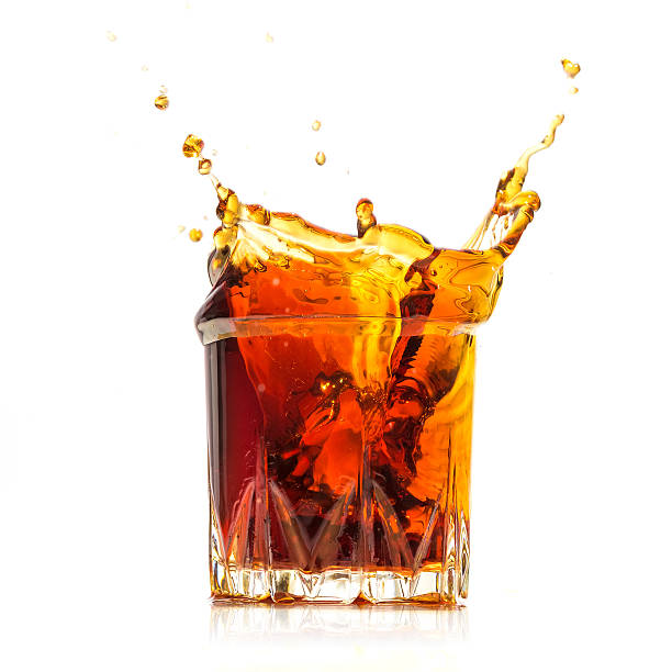 istock Glass with whiskey splash on white background 496232258