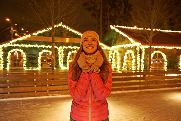 istock Young woman enjoying winter on ice rink 496233286