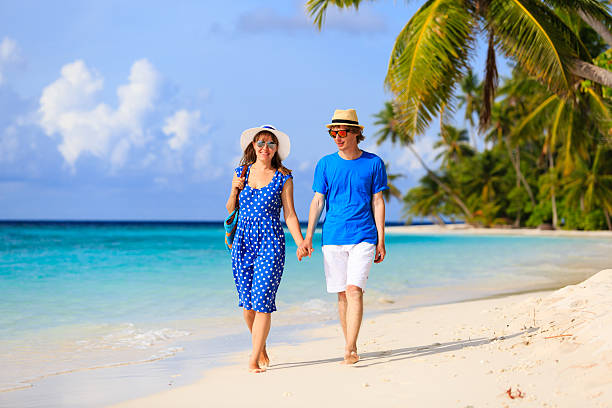 istock happy loving couple walking on summer beach 496234648