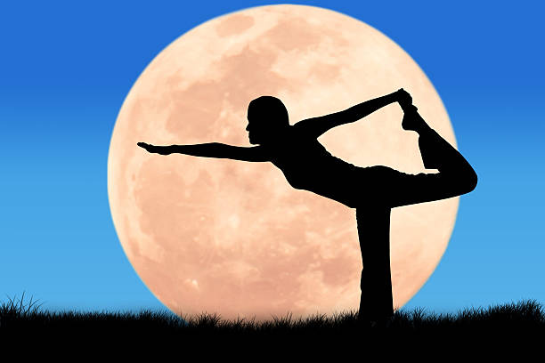 istock Silhouette young woman practicing yoga on full moon background 496234824
