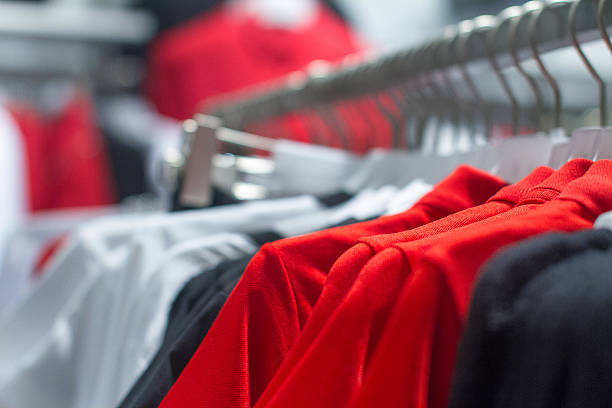 istock red shirt hanging on a hanger in the store 496235760