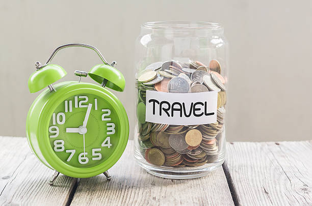 istock Money jar with coins on wood table 496235878