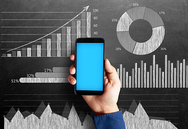 istock Business chart on blackboard with smart phone in human hand 496236470