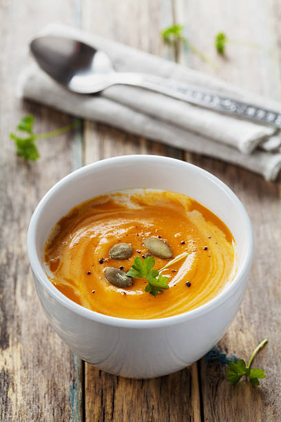 istock Carrot soup with seeds and cream, rustic style 496236642