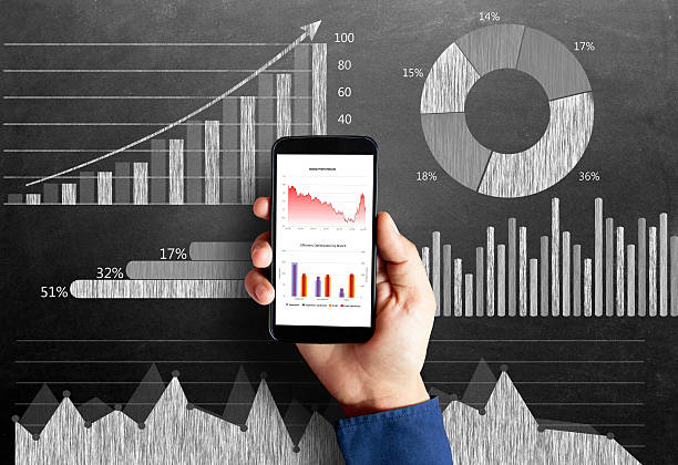 istock Business chart on blackboard with smart phone in human hand 496236730