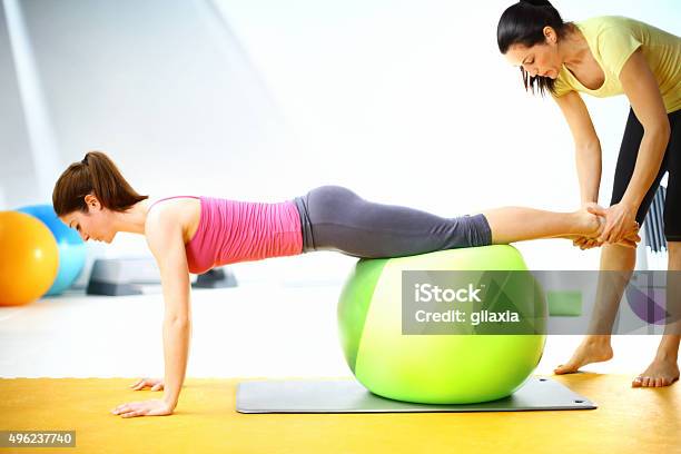 Woman Exercising With Instructor Stock Photo - Download Image Now - 20-29 Years, 2015, 30-39 Years