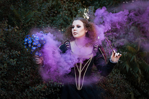 istock Woman showing tricks with a magic wand. 496238262