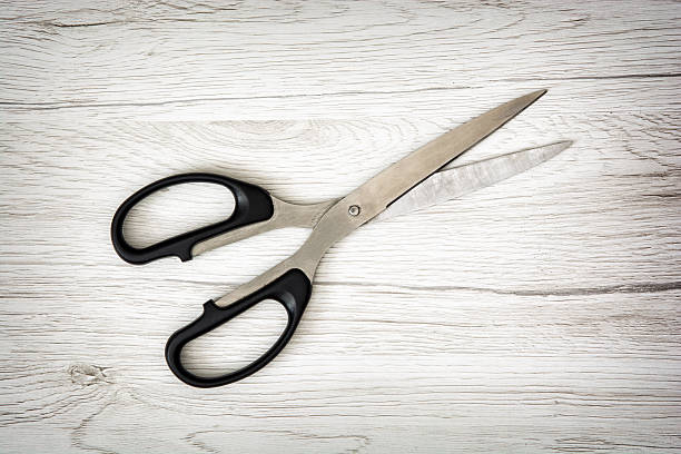 istock Office scissors on the wooden background 496238490