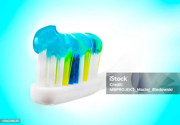 Tooth Brush With Paste On Blue And White Background Stock Photo - Download Image Now