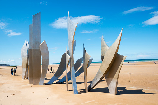 Laurent-sur-Mer, Normandy, France - May 13, 2014: Visitors to Omaha Beach walk around the sculpture entitled \