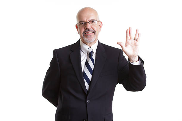 businessman businessman in dark blue suit and glasses  showing live long and prosper isolated on white background vulcan salute stock pictures, royalty-free photos & images