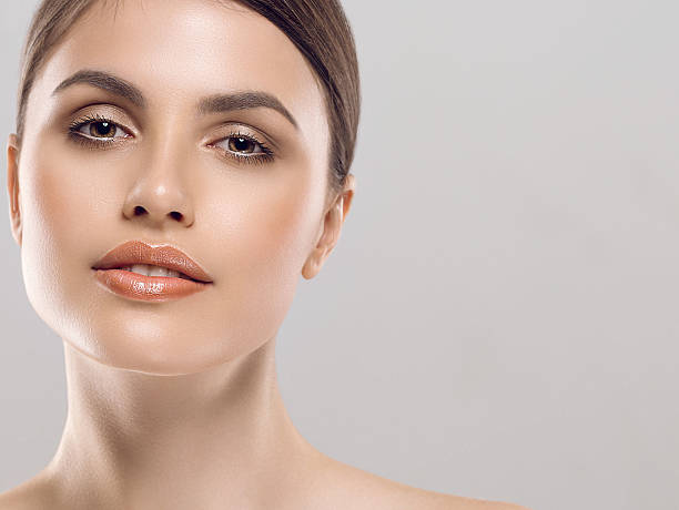 istock Beautiful woman face close up studio white sexy lips 496240390