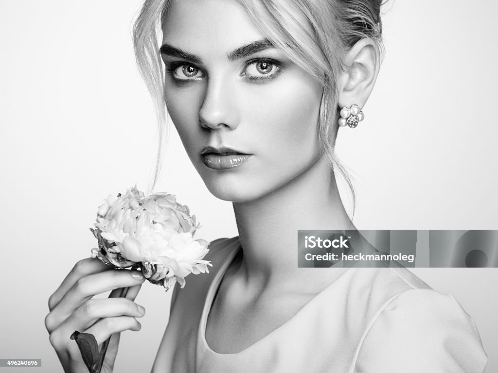 Portrait of beautiful sensual woman with elegant hairstyle Portrait of beautiful sensual woman with elegant hairstyle.  Perfect makeup. Blonde girl. Fashion photo. Flowers. Black and white 2015 Stock Photo