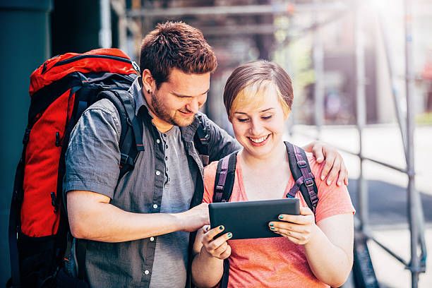 Young couple backpackers in city