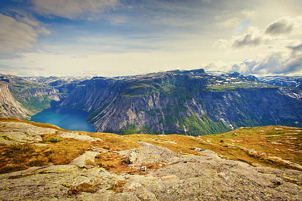 Beautiful Norwegian Summer Panorama Mountain Landscape near Trolltunga, Norway norway, nature, trolltunga, fjord, mountain, landscape, oslo, tongue, troll, hiking, norge, scandinavia, odda, summer, fjords, norwegian, lake, rock, iceland, reykjavik, ringedalsvatnet, hardanger, scandinavian, oslofjord, roldal, sognefjord, beautiful, blue, tourism, nordic, hardangervidda, prekestolen, preikestolen, kjerag, briksdal, Eidfjord, hordalann, Sognefjord, Hardangerfjord, Lysefjord, Geirangerfjord, Nordfjord, Oslofjord, Fjord Norway, Kjeragbolten, Pulpit Rock, Trollstigen, Voringsfossen, Vibrant, norway lysefjorden fjord norwegian currency stock pictures, royalty-free photos & images