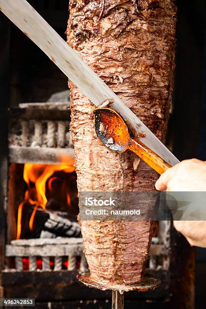 Doner Meat Being Sliced From Rotating Spit Stock Photo - Download Image Now - Cutting, Asia, Asian and Indian Ethnicities