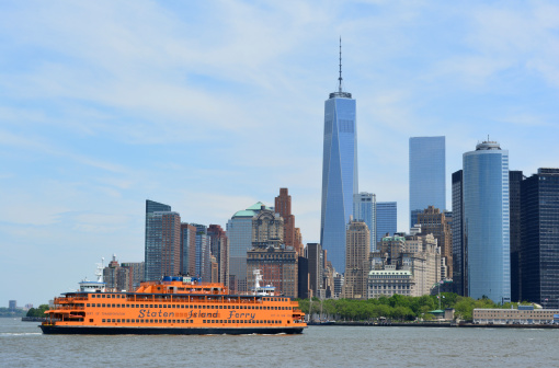 New York City, USA - May 25, 2014: Staten Island Ferry in New York Harbor with the Lower Manhattan skyline in the background on May 25, 2014.
