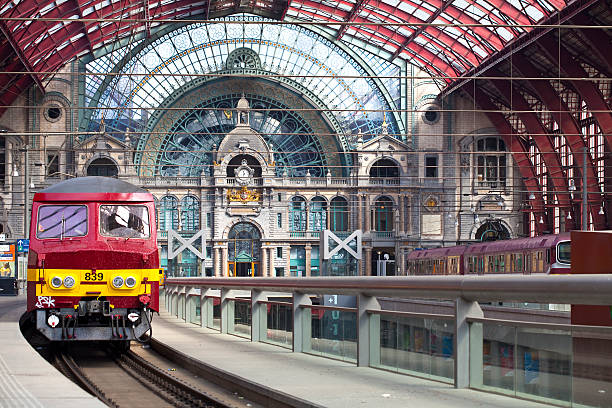 Antwerp, Belgium - April 24, 2010: The Central Station of Antwerp was constructed between 1895 and 1905. The central platforms with a local Belgium red train on the left.