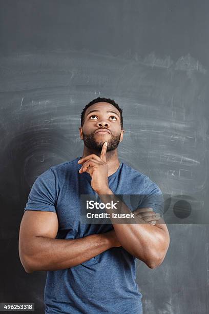 Pensive Afro American Man Against Blackboard Stock Photo - Download Image Now - Asking, Men, Contemplation