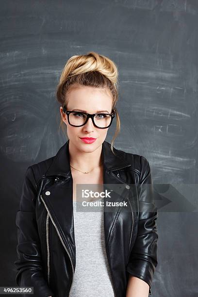 Blonde Young Woman Against Blackboard Stock Photo - Download Image Now - Women, Black Color, Blond Hair