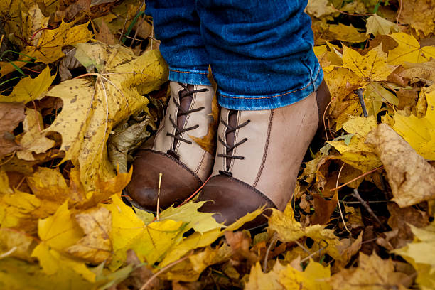 istock autumn, leaves, legs and shoes. 496254220