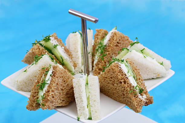 istock White and brown cream cheese, cucumber sandwiches on cake tray 496254246