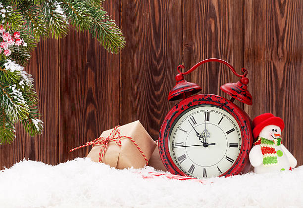 istock Christmas gift boxes, alarm clock and fir tree branch 496254590