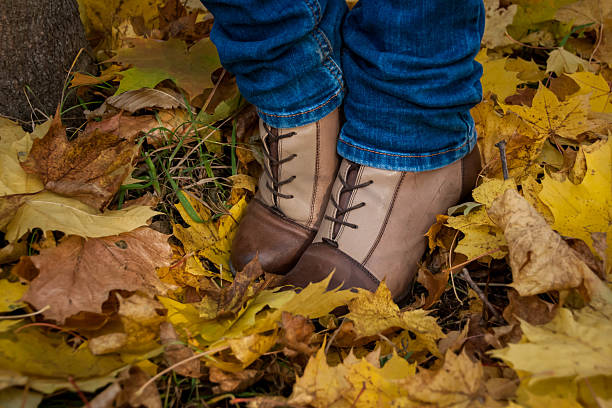 istock autumn, leaves, legs and shoes. 496254884