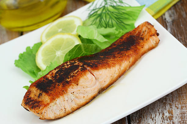 istock Grilled salmon steak with green salad and lemon 496255256