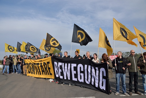 Nickelsdorf, Austria – October 17, 2015: activists of the identitarian movement Austria block the access-road to the border from Hungary to Austria at Nickelsdorf.